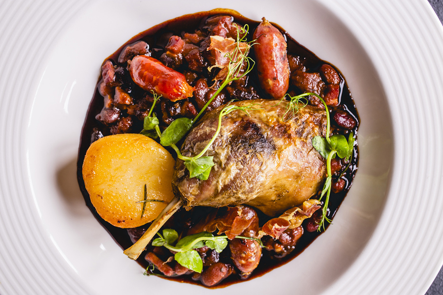 Confit Duck Leg Cassoulet, fondant potato, Trealy Farm sausage, mixed